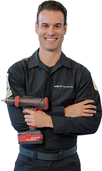 Smiling mechanic with arms crossed holds a wrench.
